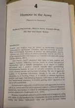Zdjęcie otwartej strony książki naukowej. Widoczny jest nagłówek rozdziału 4 zatytułowany „Humour in the Army: Pleasure or Necessity?”. Pod tytułem wymienieni są autorzy: Andrzej Piotrowski, Marcin Szulc, Gayatri Ahuja, Ole Boe oraz Samir Rawat. Tekst poniżej to wprowadzenie (Introduction) omawiające psychologiczne funkcje humoru, cytujące m.in. publikacje Martina z 2007 roku.