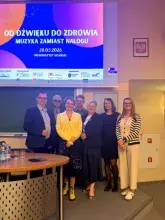 Zdjęcie przedstawiające prelegentów na tle rzutnika z organizowanej konferencji`